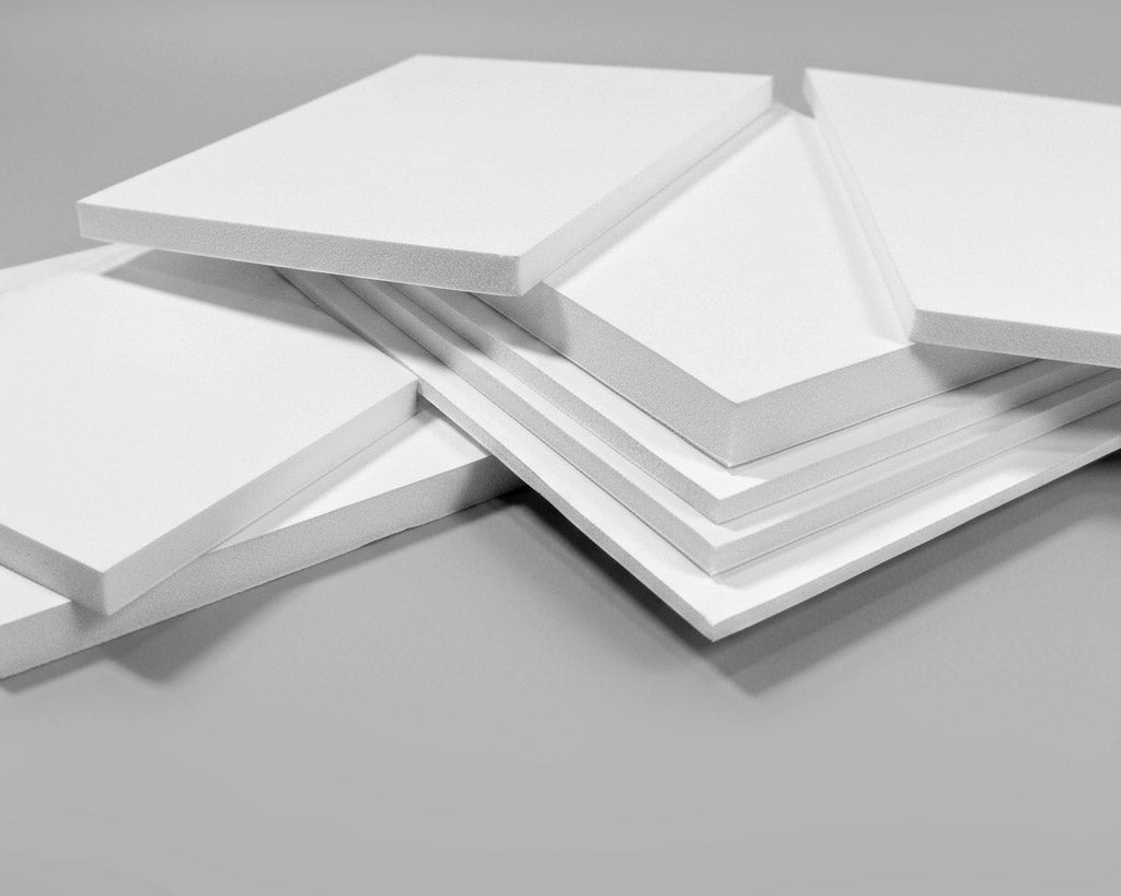 Stack of white foam boards on a gray background