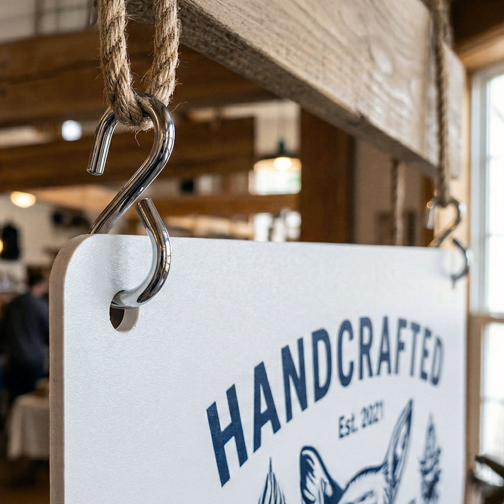 Metal hook for hanging foam boards with drilled holes